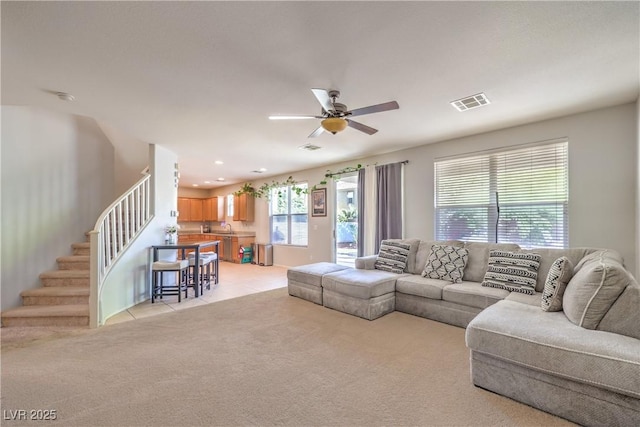 1213 High Altitude Ave, North Las Vegas, NV 89032 - living room with a ceiling fan, light colored carpet, stairway, light tile patterned floors, and recessed lighting