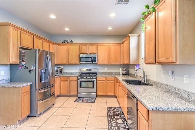 1213 High Altitude Ave, North Las Vegas, NV 89032 - kitchen with appliances with stainless steel finishes, a sink, light tile patterned floors, recessed lighting, and light stone countertops