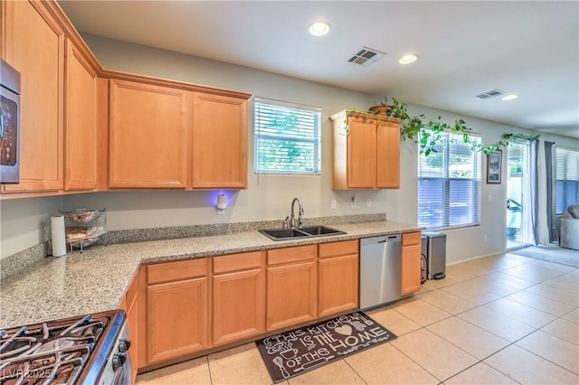 1213 High Altitude Ave, North Las Vegas, NV 89032 - kitchen with appliances with stainless steel finishes, a sink, light tile patterned flooring, recessed lighting, and light brown cabinetry