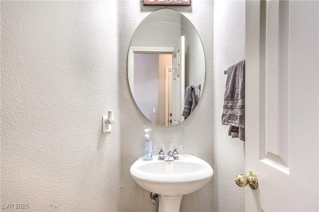1213 High Altitude Ave, North Las Vegas, NV 89032 - bathroom with a textured wall and a sink