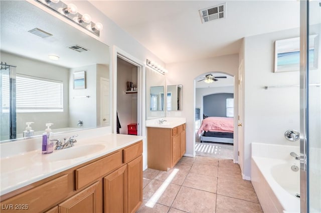 1213 High Altitude Ave, North Las Vegas, NV 89032 - full bathroom featuring ceiling fan, a bath, tile patterned flooring, ensuite bath, and two vanities