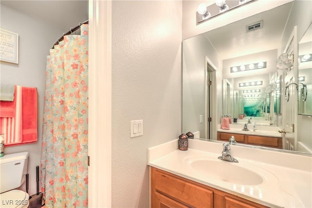 1213 High Altitude Ave, North Las Vegas, NV 89032 - full bathroom with toilet, vanity, a shower with shower curtain, and a textured wall