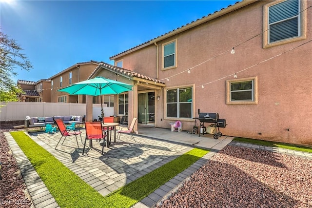 1213 High Altitude Ave, North Las Vegas, NV 89032 - back of property with an outdoor hangout area, fence, stucco siding, and a patio