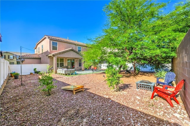 1213 High Altitude Ave, North Las Vegas, NV 89032 - back of house with stucco siding, a patio, a fenced backyard, and an outdoor fire pit