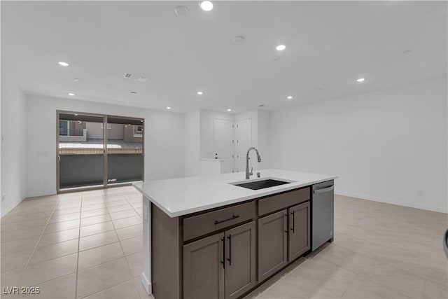 kitchen with a sink, dishwasher, a kitchen island with sink, light countertops, and recessed lighting