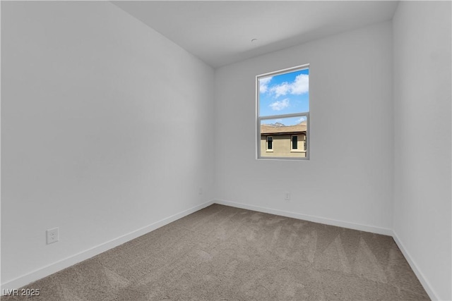 empty room with carpet flooring and baseboards