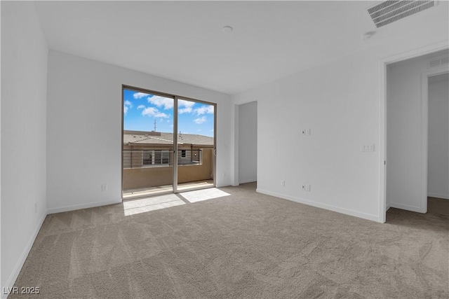 carpeted empty room with baseboards