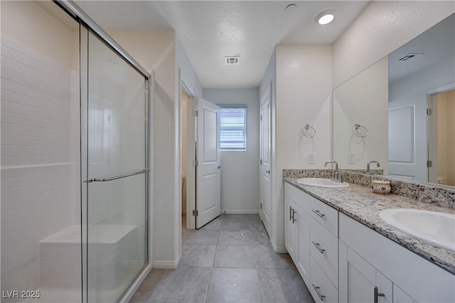 387 Larksong Ave, Henderson, NV 89011 - bathroom with a stall shower, double vanity, baseboards, and tile patterned floors