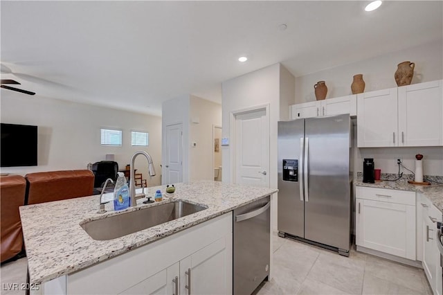 387 Larksong Ave, Henderson, NV 89011 - kitchen with stainless steel appliances, a sink, open floor plan, white cabinets, and recessed lighting