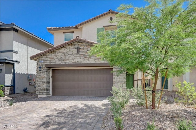 387 Larksong Ave, Henderson, NV 89011 - view of front of home featuring stone siding, an attached garage, a tile roof, and stucco siding