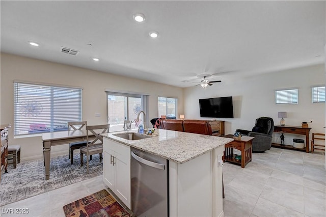 387 Larksong Ave, Henderson, NV 89011 - kitchen with stainless steel dishwasher, light tile patterned flooring, light stone countertops, white cabinetry, and a desk