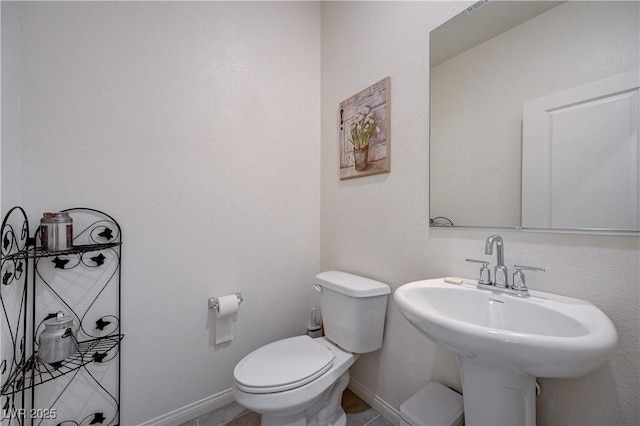 387 Larksong Ave, Henderson, NV 89011 - bathroom with toilet, baseboards, a sink, and tile patterned flooring