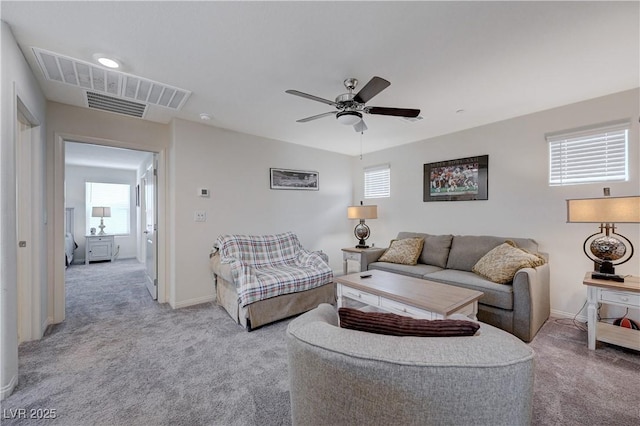 387 Larksong Ave, Henderson, NV 89011 - carpeted living room featuring plenty of natural light, a ceiling fan, and baseboards