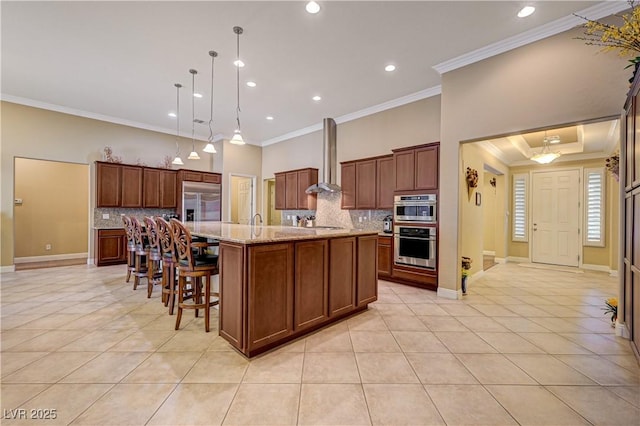 kitchen featuring light tile patterned floors, ornamental molding, wall chimney range hood, tasteful backsplash, and recessed lighting