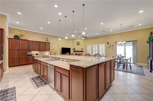 kitchen with a sink, dishwasher, light tile patterned floors, ornamental molding, and a spacious island
