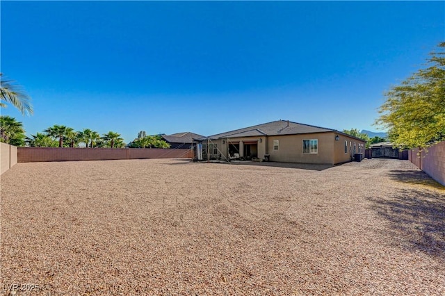 back of house with a fenced backyard