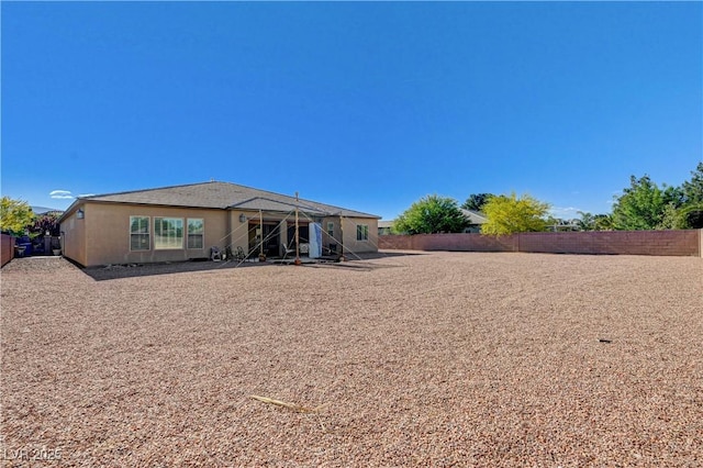 back of property with a fenced backyard