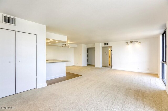 3930 University Center Dr Unit 311, Las Vegas, NV 89119 - unfurnished living room featuring light carpet and baseboards