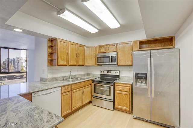 3930 University Center Dr Unit 311, Las Vegas, NV 89119 - kitchen featuring appliances with stainless steel finishes, open shelves, a sink, light wood finished floors, and decorative backsplash