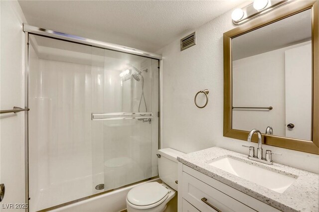 3930 University Center Dr Unit 311, Las Vegas, NV 89119 - bathroom featuring a shower with door, toilet, vanity, and a textured ceiling