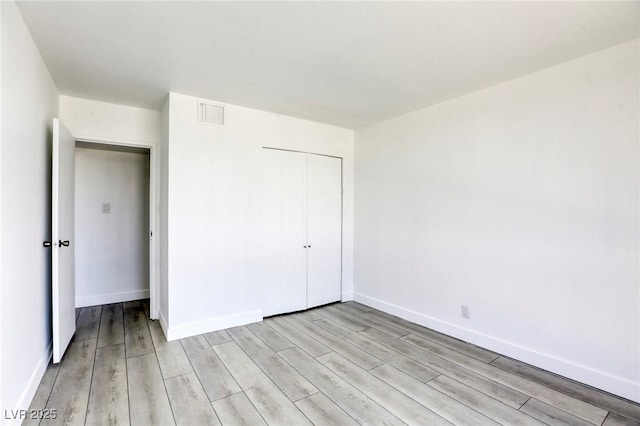 3930 University Center Dr Unit 312, Las Vegas, NV 89119 - unfurnished bedroom featuring light wood finished floors, a closet, and baseboards