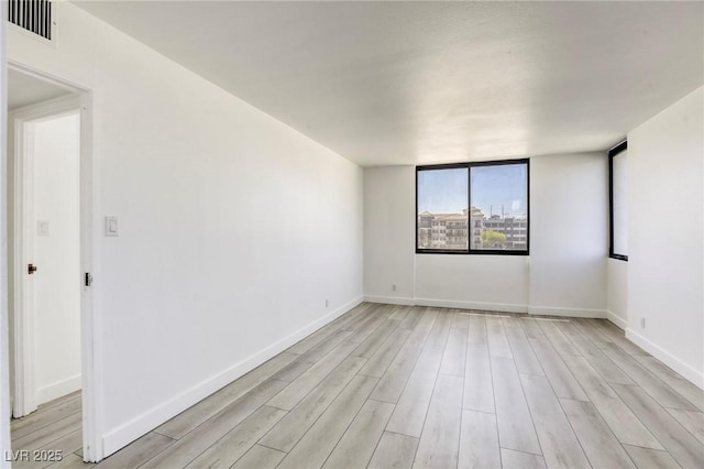 3930 University Center Dr Unit 312, Las Vegas, NV 89119 - spare room featuring light wood-style flooring and baseboards