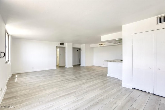3930 University Center Dr Unit 312, Las Vegas, NV 89119 - unfurnished living room with light wood-type flooring and baseboards