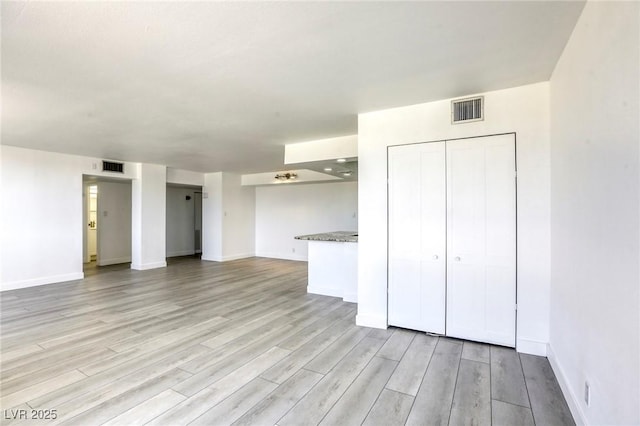 3930 University Center Dr Unit 312, Las Vegas, NV 89119 - unfurnished living room featuring light wood-style floors and baseboards