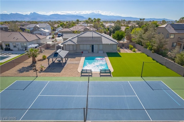 8228 Fulton Ranch St, Las Vegas, NV 89131 - view of tennis court with a residential view, a mountain view, and a patio area