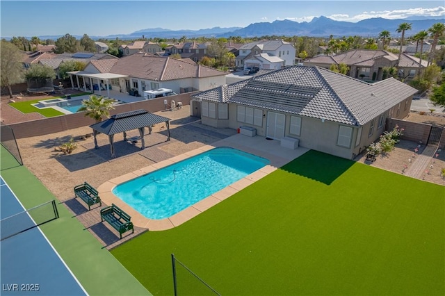 8228 Fulton Ranch St, Las Vegas, NV 89131 - view of pool with a residential view, a fenced backyard, a mountain view, and a gazebo