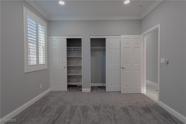 unfurnished bedroom featuring ornamental molding, carpet floors, multiple closets, baseboards, and recessed lighting