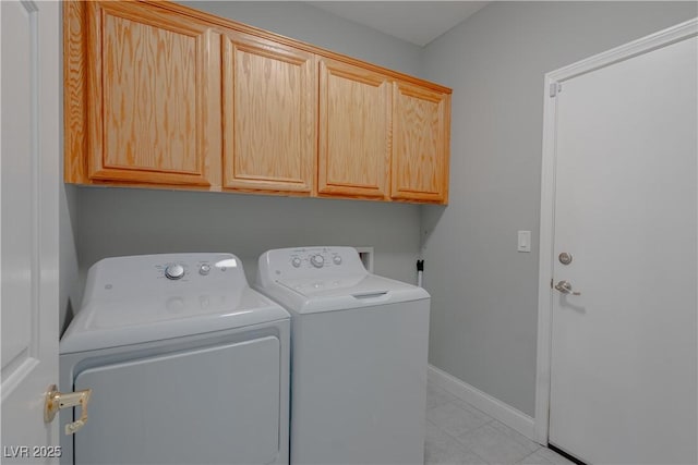 8228 Fulton Ranch St, Las Vegas, NV 89131 - laundry area featuring washer and clothes dryer, cabinet space, and light tile patterned floors