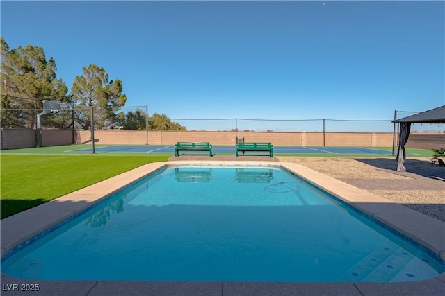 view of swimming pool featuring community basketball court