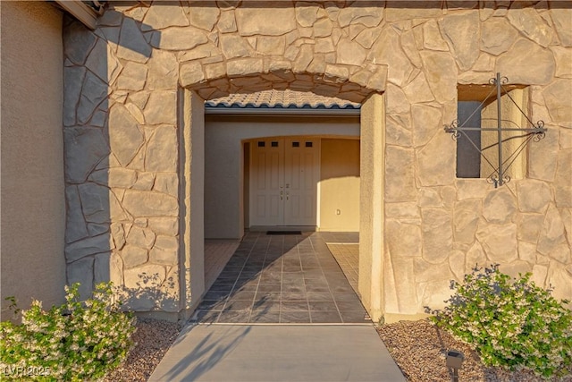 property entrance featuring stone siding