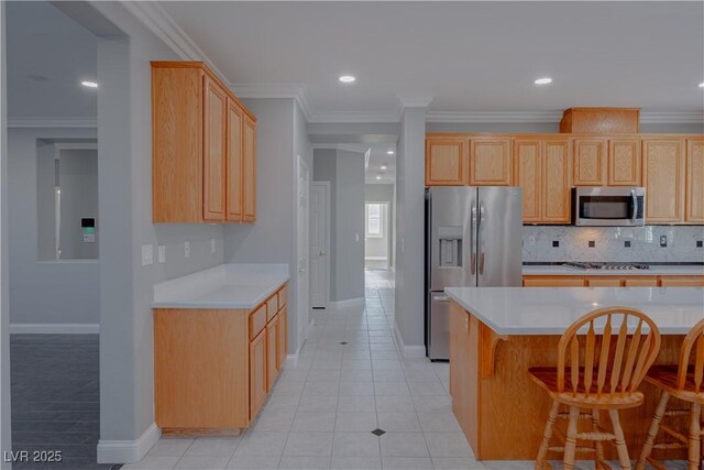 8228 Fulton Ranch St, Las Vegas, NV 89131 - kitchen with appliances with stainless steel finishes, light countertops, tasteful backsplash, a breakfast bar, and ornamental molding