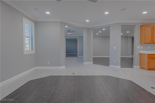 unfurnished living room with a ceiling fan, ornamental molding, recessed lighting, baseboards, and wood finished floors
