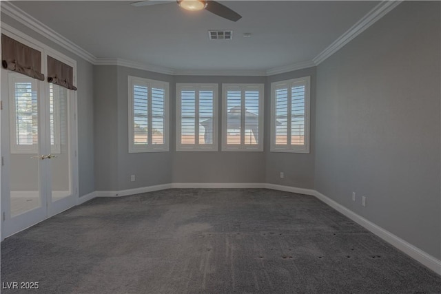 carpeted spare room with crown molding, ceiling fan, and baseboards
