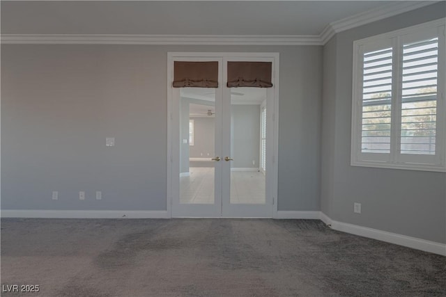 carpeted spare room with french doors, ornamental molding, healthy amount of natural light, and baseboards