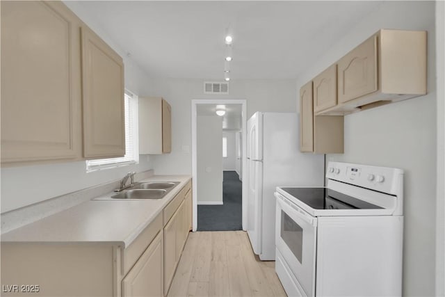 2016 Linden Ave, Las Vegas, NV 89101 - kitchen with electric range, a sink, light countertops, light wood finished floors, and light brown cabinets