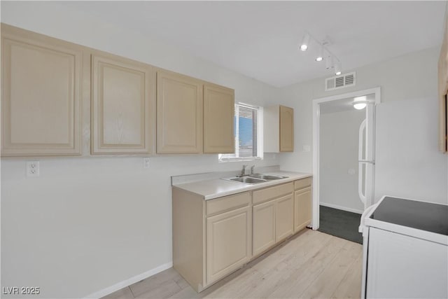 2016 Linden Ave, Las Vegas, NV 89101 - kitchen with electric stove, a sink, freestanding refrigerator, light countertops, and baseboards