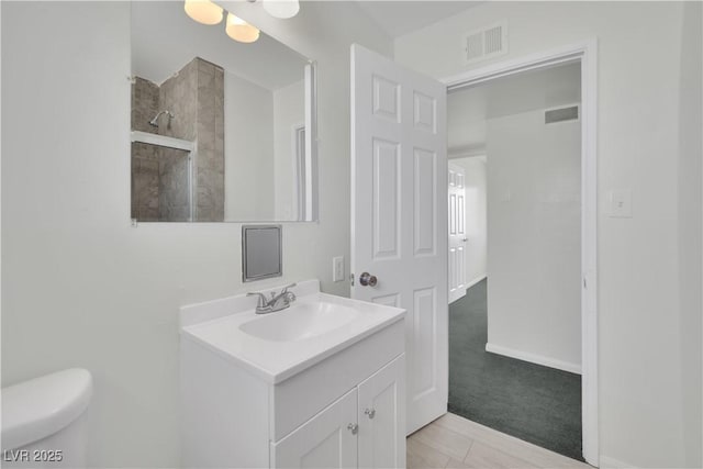 2016 Linden Ave, Las Vegas, NV 89101 - bathroom with vanity, toilet, tiled shower, and baseboards