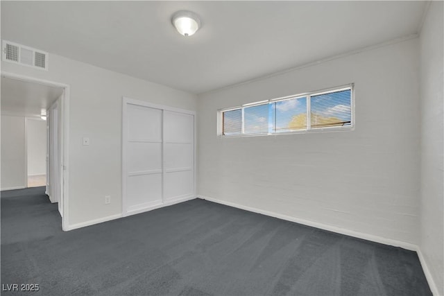 2016 Linden Ave, Las Vegas, NV 89101 - unfurnished bedroom featuring dark colored carpet, baseboards, and a closet