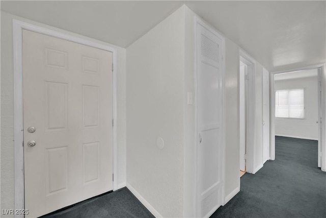 2016 Linden Ave, Las Vegas, NV 89101 - hallway featuring dark carpet and baseboards