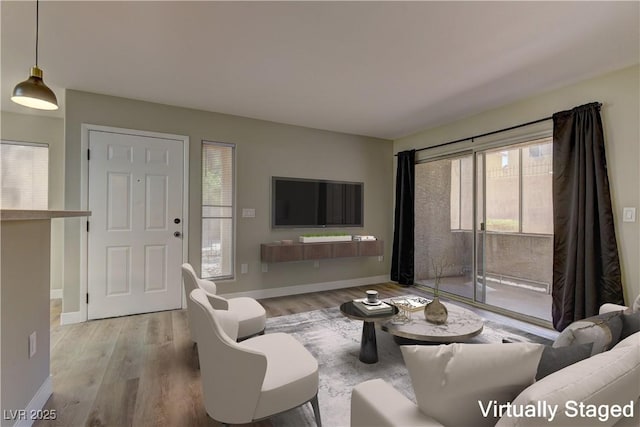 living room with wood finished floors and baseboards