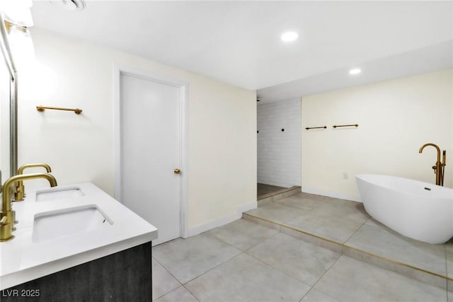 1679 Raindance Way, Las Vegas, NV 89169 - full bath featuring a freestanding bath, tile patterned flooring, recessed lighting, double vanity, and baseboards