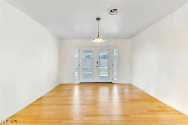 1679 Raindance Way, Las Vegas, NV 89169 - unfurnished dining area with light wood-type flooring, french doors, and baseboards