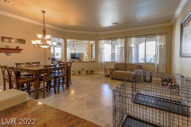 living area featuring a chandelier, crown molding, and baseboards