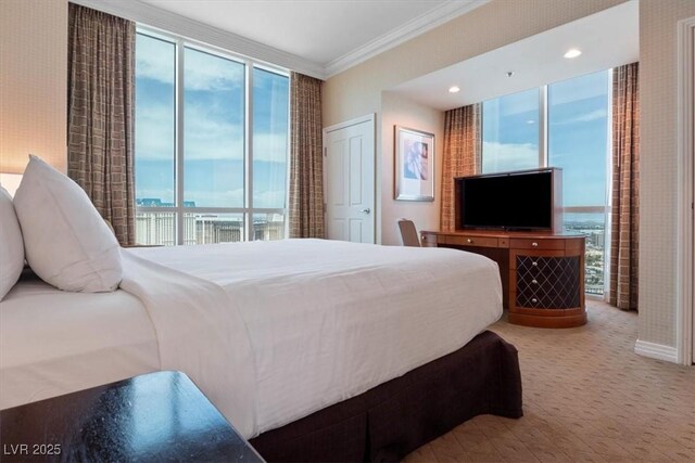 125 E Harmon Ave Unit 321, Las Vegas, NV 89109 - bedroom featuring ornamental molding, carpet floors, and expansive windows