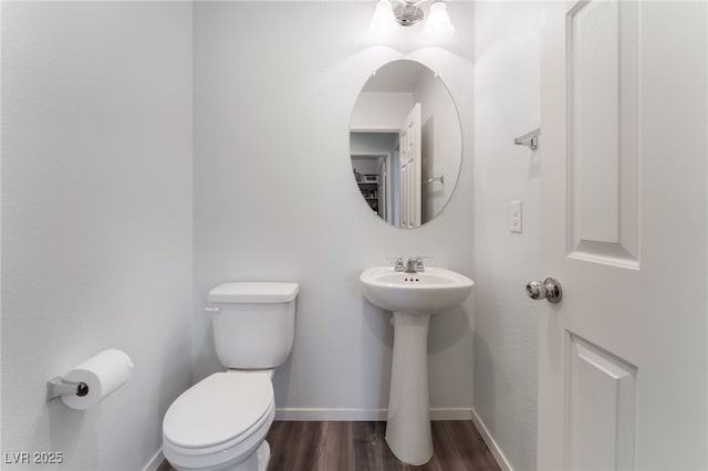 4650 Ranch House Rd Unit 86, North Las Vegas, NV 89031 - half bathroom featuring toilet, wood finished floors, baseboards, and a sink
