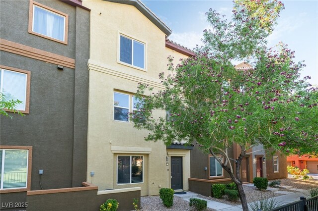 4650 Ranch House Rd Unit 86, North Las Vegas, NV 89031 - back of house featuring stucco siding